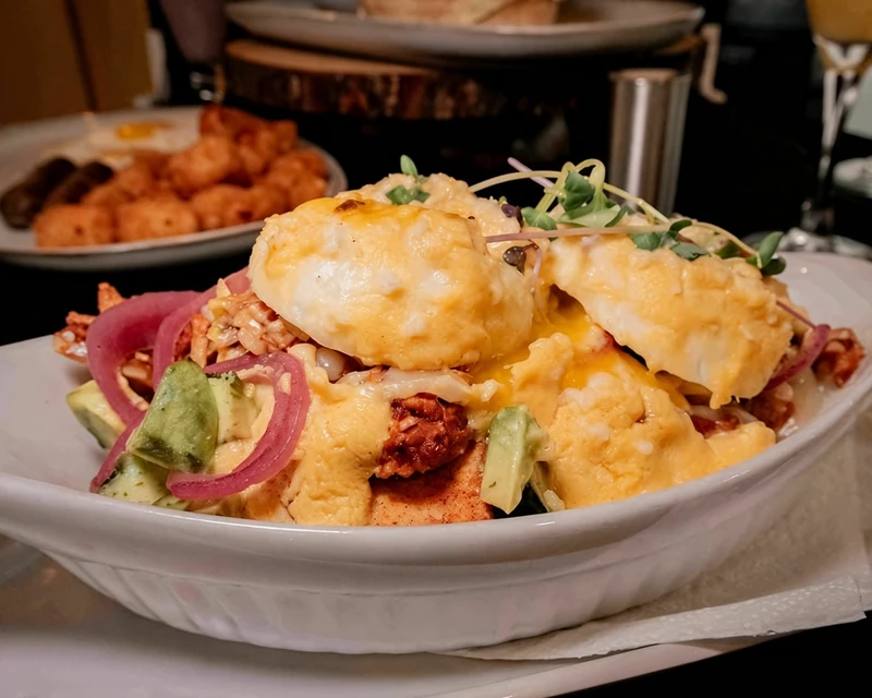 Eggs Benedict with hollandaise and greens at Rise & Dine Calgary SE